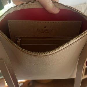 Kate Spade tan with red accents purse. Never used.